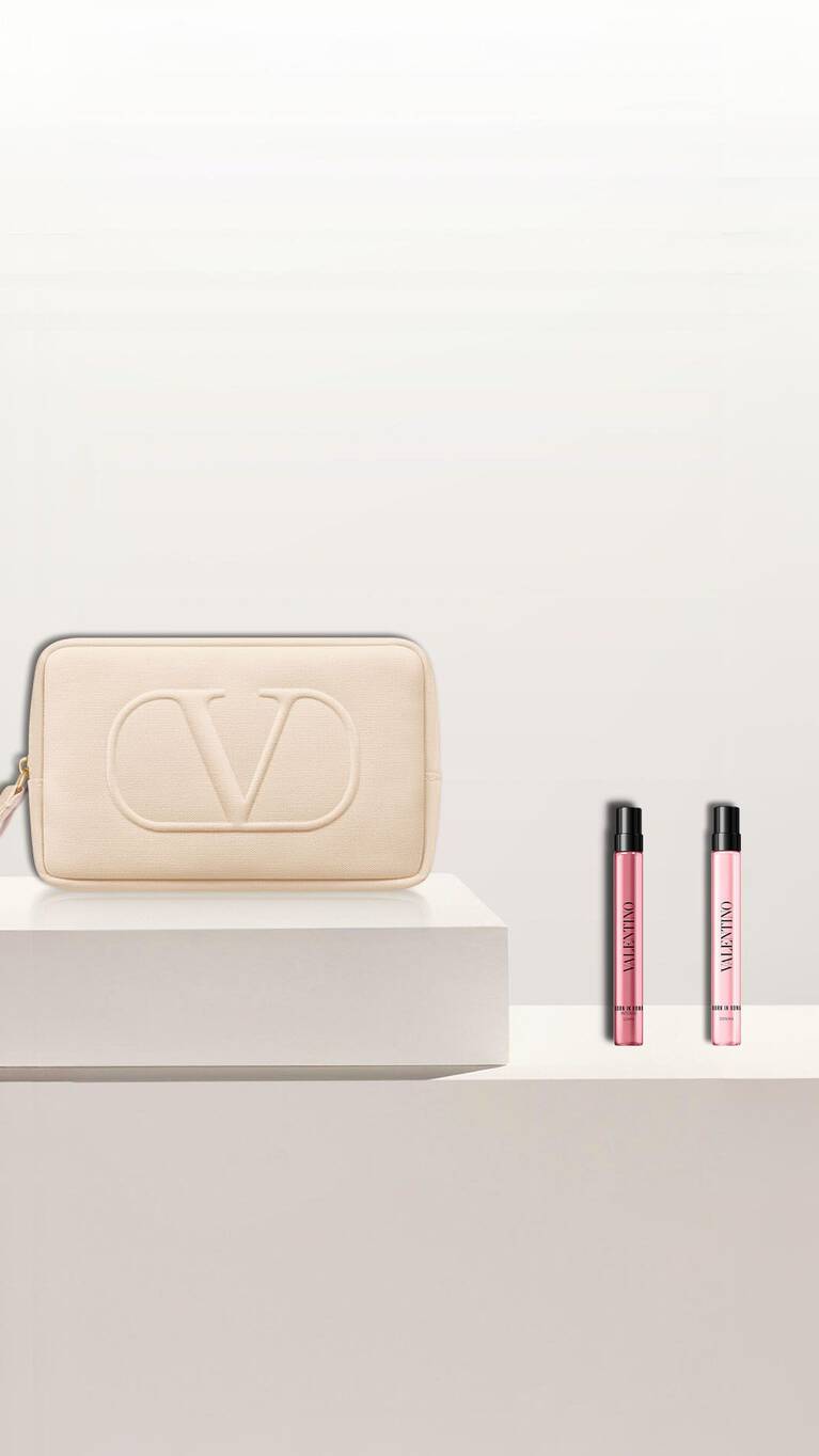 A vibrant green cosmetic pouch with a luxurious logo, accompanied by three elegant beauty products in stylish packaging.