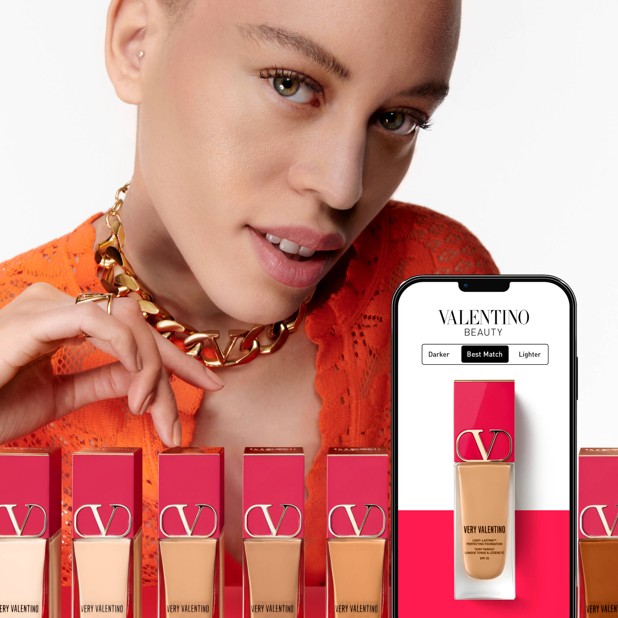 A model wearing an orange top smiles while showcasing a foundation shade from Valentino Beauty. Surrounding her are various foundation bottles in different shades, and a smartphone displaying the product's color matching options.