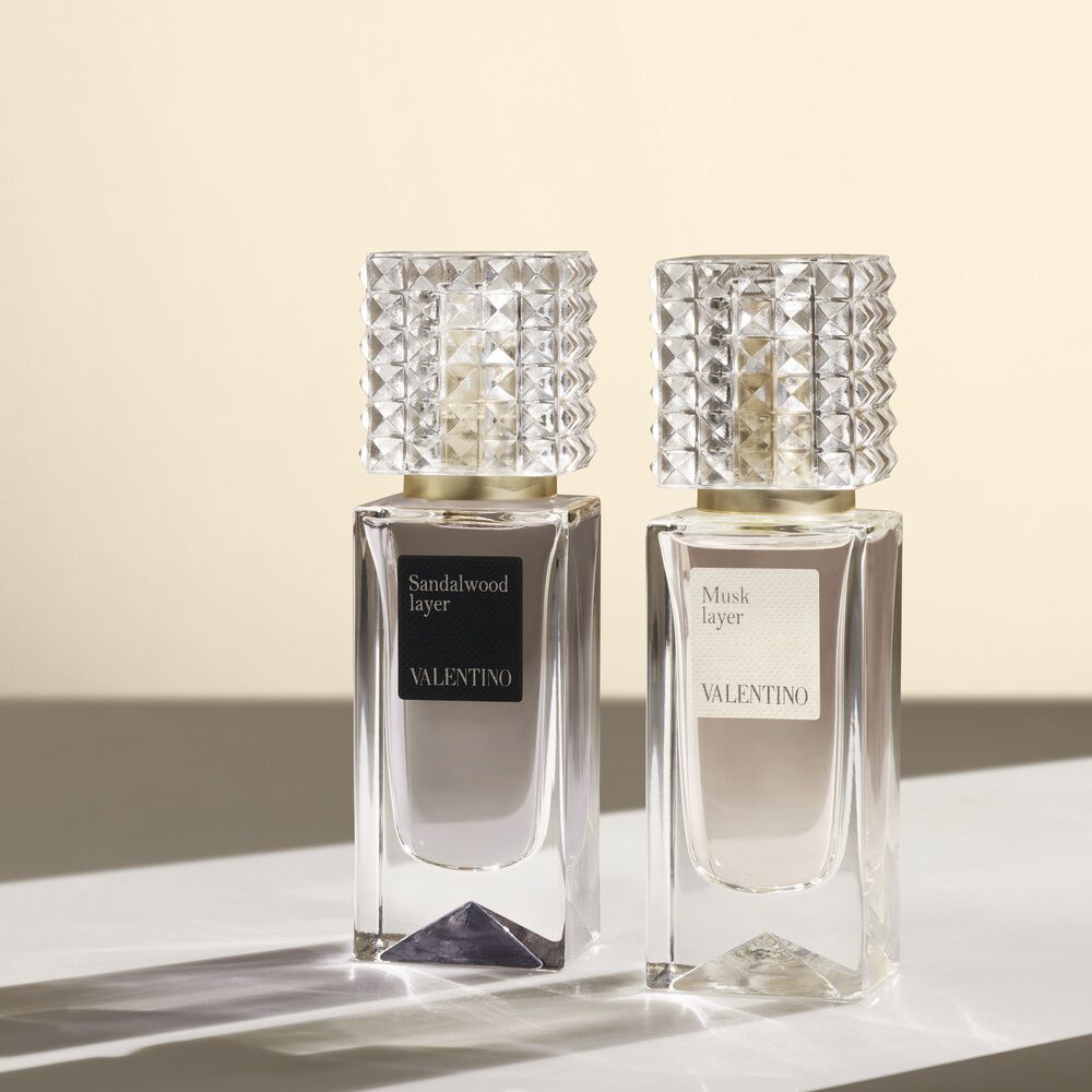 Two Valentino perfume bottles labeled Sandalwood Layer and Musk Layer displayed on a light surface