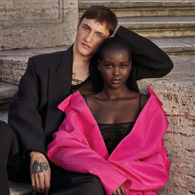 Two Valentino beauty models leaned against each other.