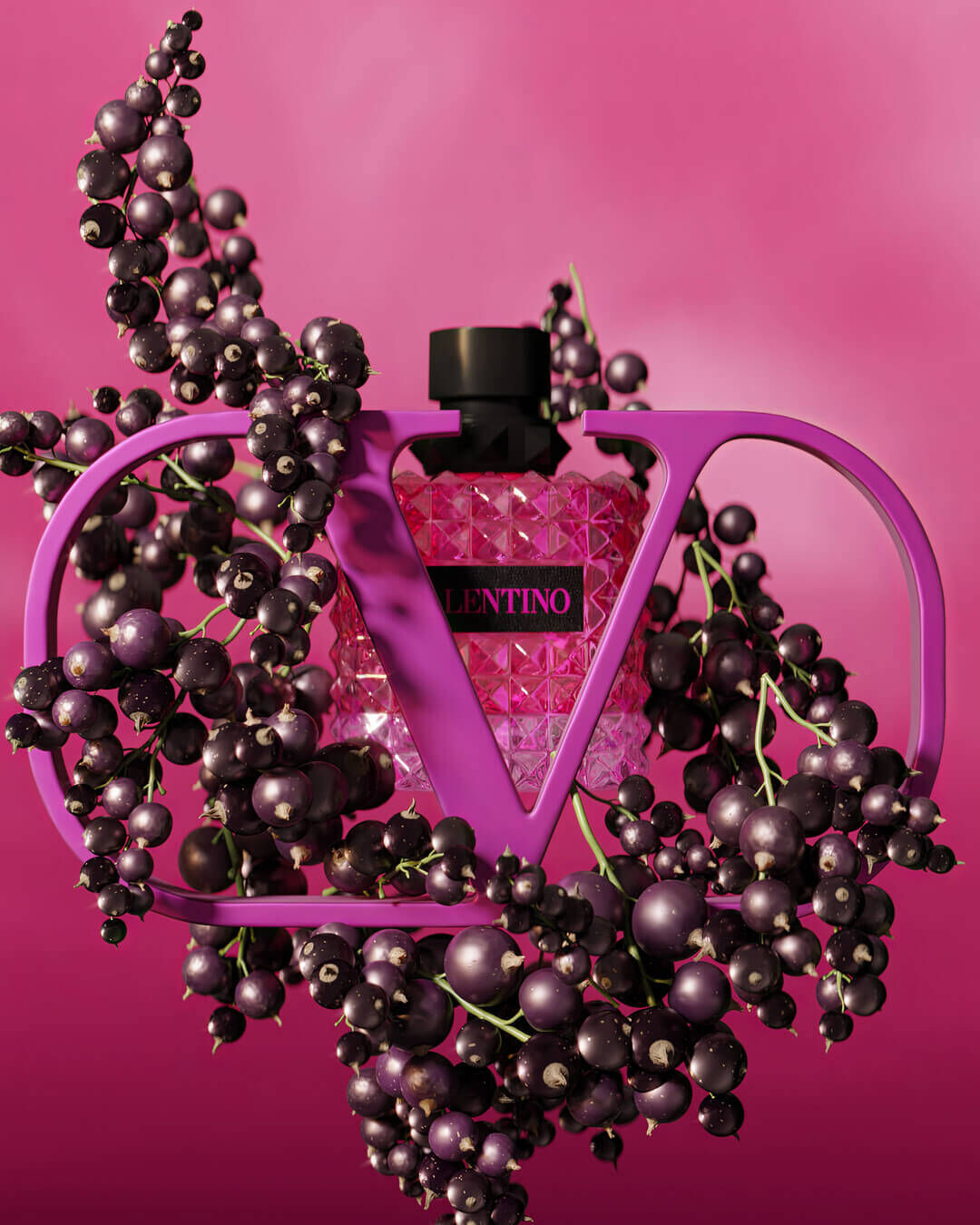A pink crystal perfume bottle with a black cap is framed by vibrant purple "V" letters, surrounded by dark berries on a soft pink background.